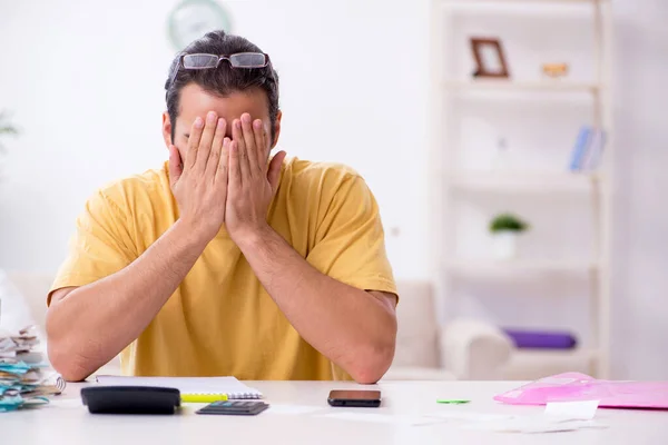 Young man in budget planning concept — Stock Photo, Image