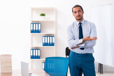 Young male employee in business presentation concept