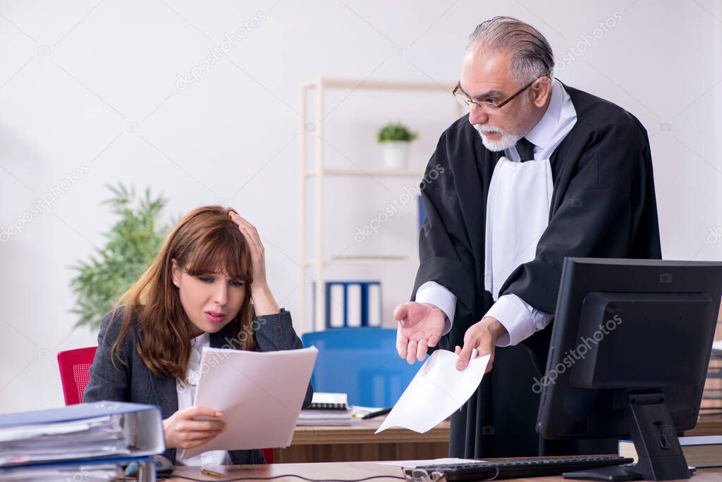 Old male judge and his young secretary in the office