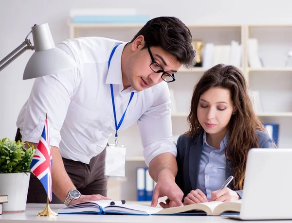 Teacher explaining to student at language training