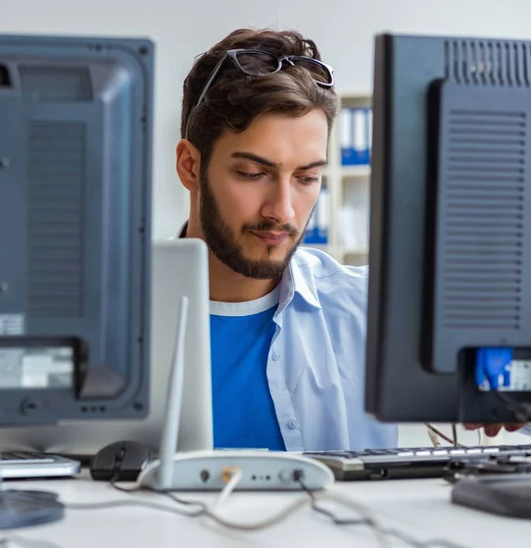 IT technician looking at IT equipment