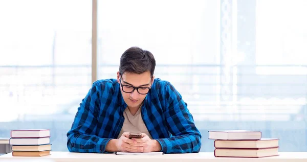 Student studying in the empty library with book preparing for ex