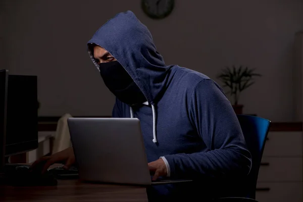 Male hacker hacking security firewall late in office — Stock Photo, Image