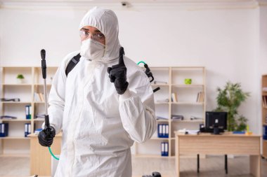 Contractor disinfecting office for COVID-19 coronavirus clipart