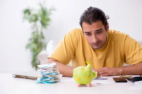 Young man in budget planning concept — Stock Photo, Image