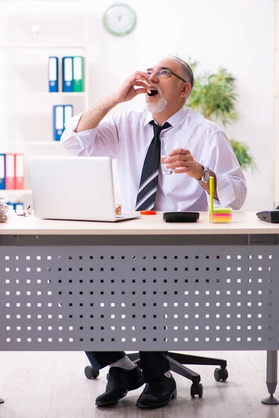 Vieil employé malade souffrant sur le lieu de travail — Photo