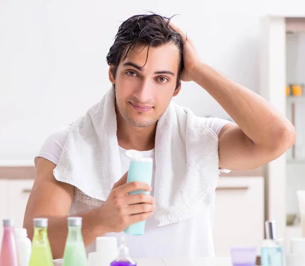 Young handsome man in the bathroom in hygiene concept — Stock Photo, Image