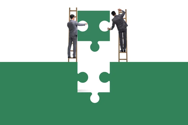 Businessman in teamwork concept with jigsaw puzzle — Stock Photo, Image