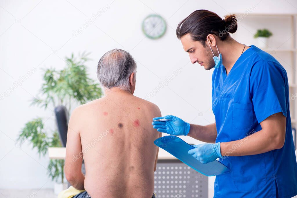 Old man visiting young male doctor dermatologist
