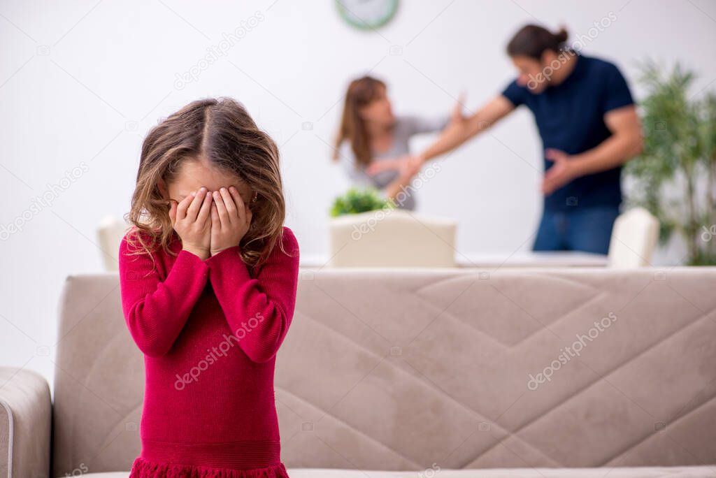 Young couple and their daughter in family conflict concept