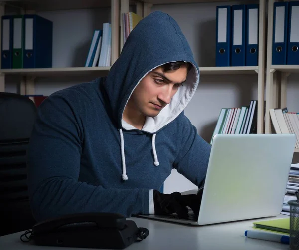 Young hacker hacking into computer at night — Stock Photo, Image