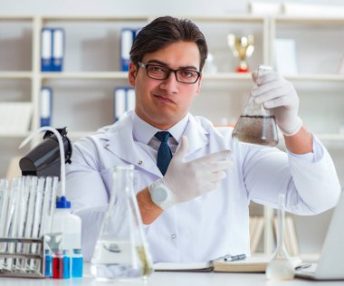 Genç araştırmacı bilim adamı bir su testi kirliliği araştırması yapıyor.