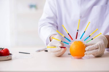 Erkek beslenme uzmanı gıda ürünlerini laboratuarda test ediyor.