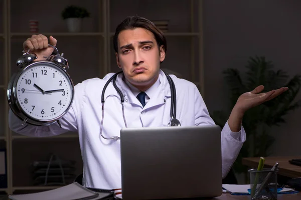 Young male doctor in the hospital at night — Stock Photo, Image