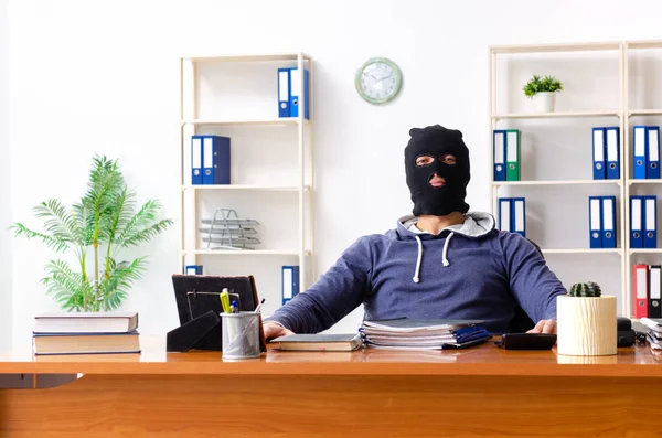 Männlicher Dieb mit Sturmhaube im Büro — Stockfoto