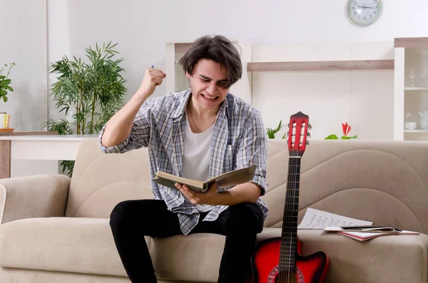 Giovane con chitarra a casa — Foto Stock