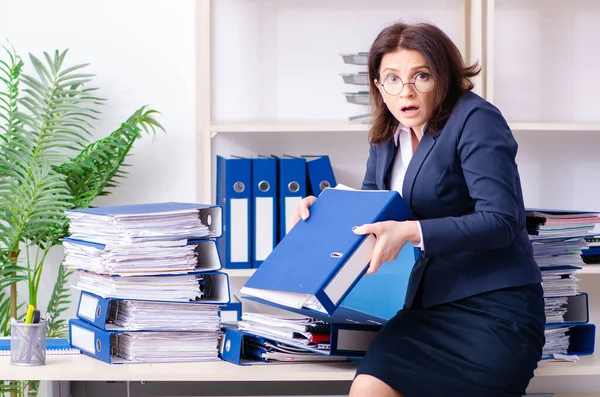 Middle-aged businesswoman unhappy with excessive work — Stock Photo, Image