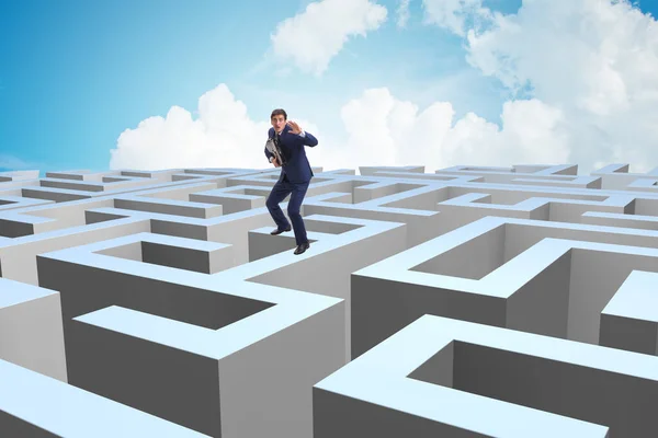 Businessman trying to escape from maze — Stock Photo, Image