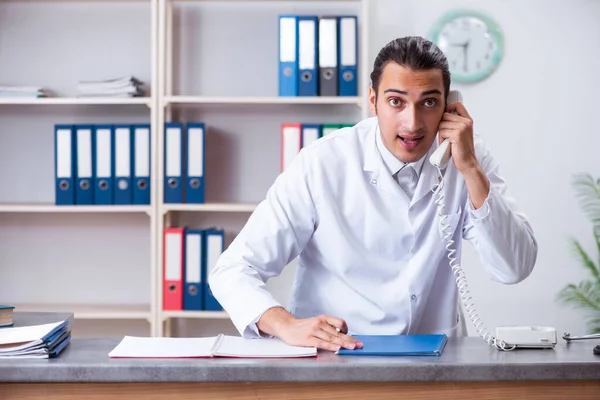 Ung manlig läkare i receptionen på sjukhuset — Stockfoto