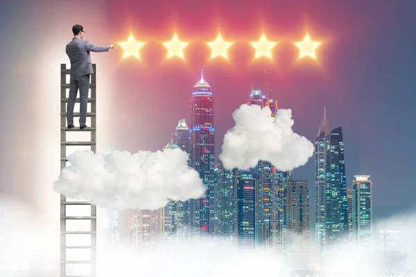 Businessman reaching out for stars — Stock Photo, Image