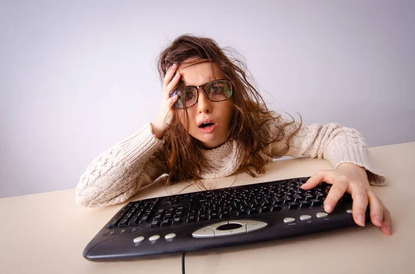 Funny nerd girl working on computer