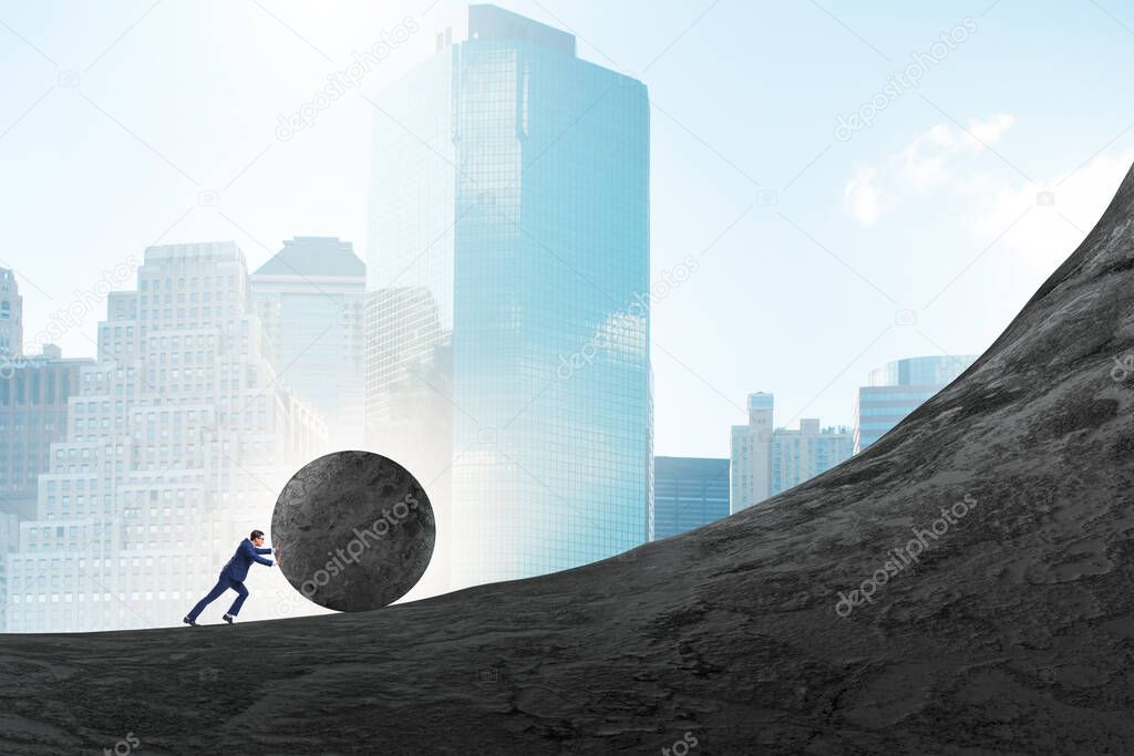 Man pushing large stone to the top