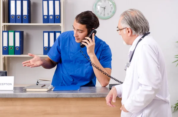 Dva lékaři mluví na recepci v nemocnici — Stock fotografie
