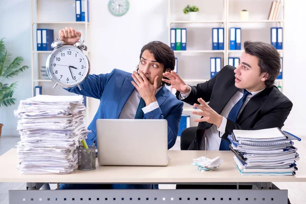 Two male colleagues unhappy with excessive work