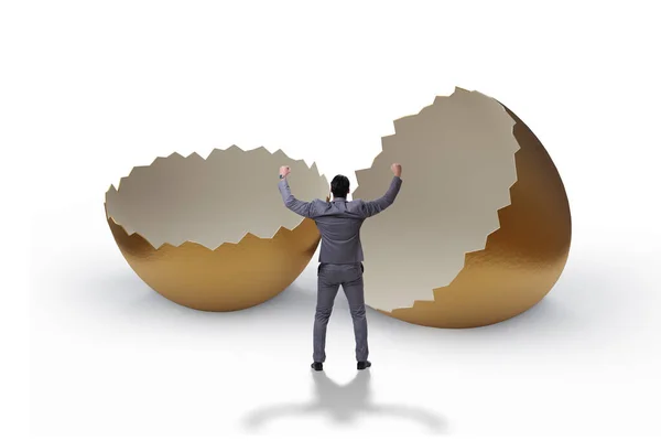 Businessman breaking out of golden egg — Stock Photo, Image