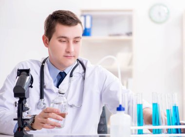 Hastanedeki laboratuvar sonuçlarına bakan erkek doktor.