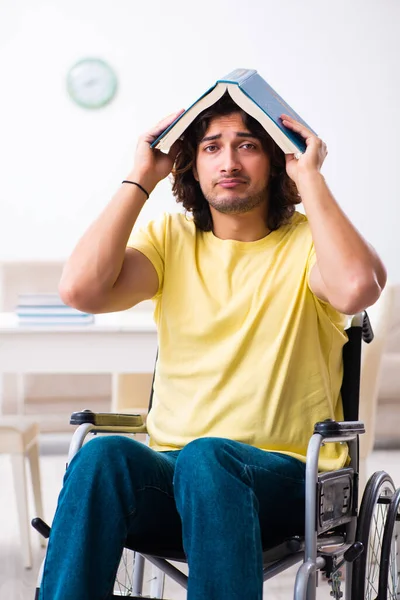 Male disabled student preparing for exams at home