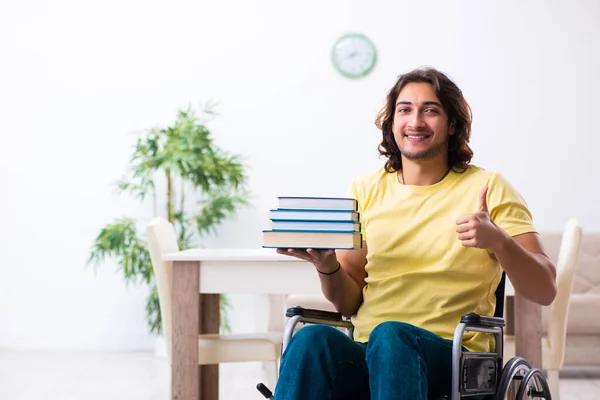 Male disabled student preparing for exams at home