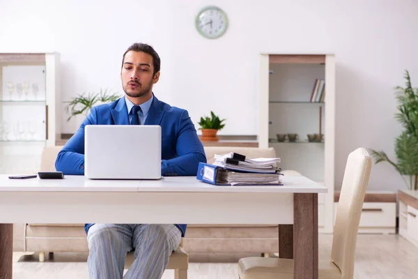 Young male employee working from house in self-isolation concept — Stock Photo, Image