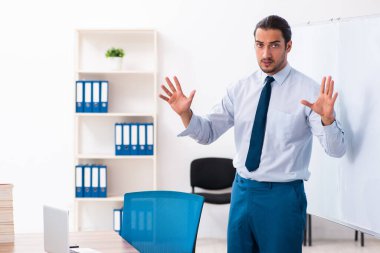 Young male employee in business presentation concept