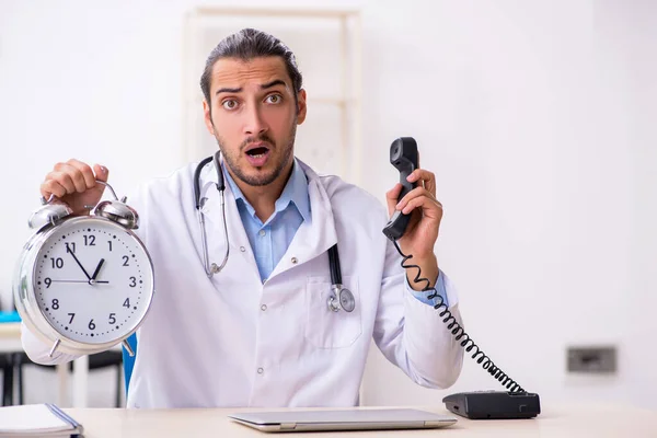 Young handsome male doctor working in the clinic — Stock Photo, Image