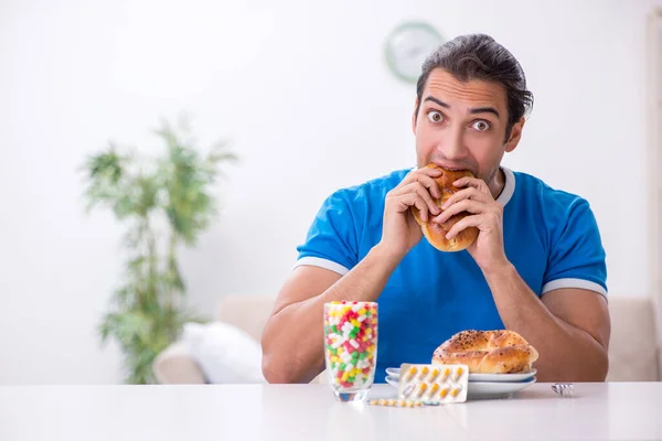 Joven hombre hambriento en concepto de dieta —  Fotos de Stock