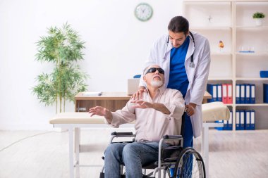 Yaşlı kör adam genç erkek doktoru ziyaret ediyor.