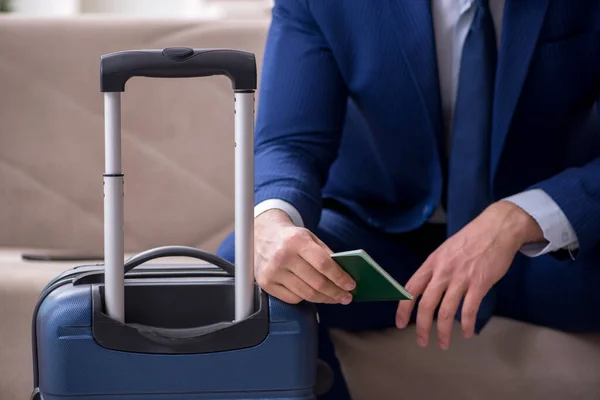 Young businessman holding passport preparing for trip — Stock Photo, Image