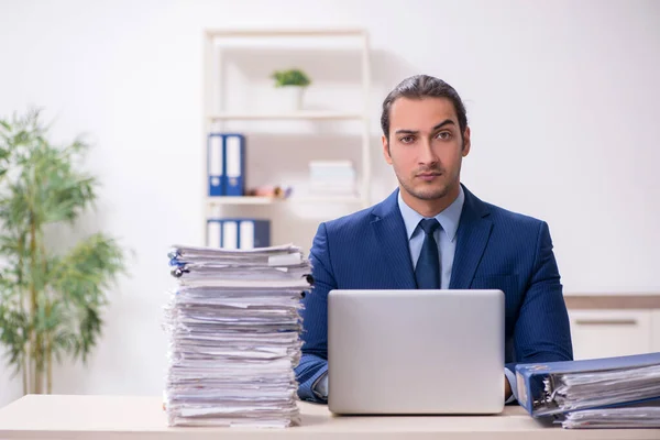Young male employee unhappy with excessive work — Stock Photo, Image