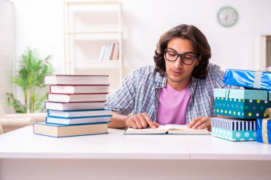 Young male student preparing for exams during Christmas