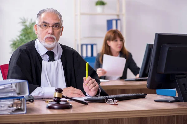 Old male judge and his young secretary in the office — Stock Photo, Image