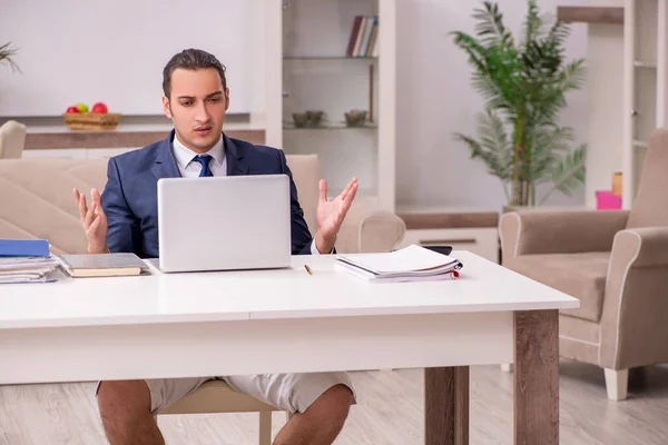 Young male employee working at home during pandemic disease — Stock Photo, Image