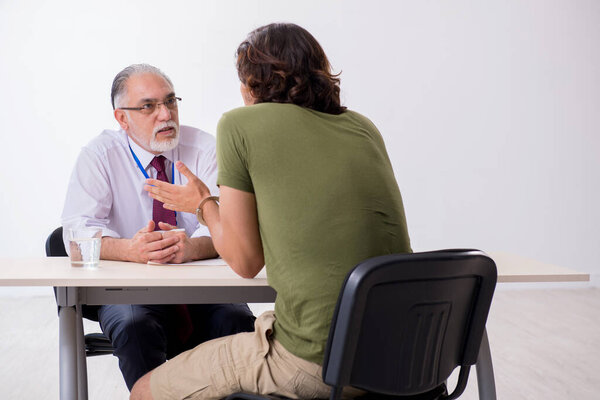 Young man meeting with advocate in pre-trial detention