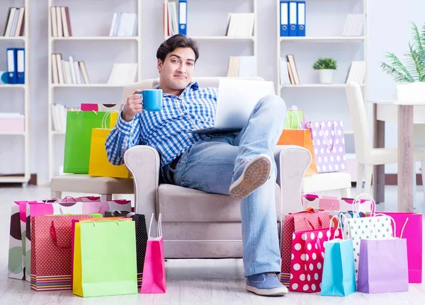 Young man after excessive shopping at home — Stock Photo, Image