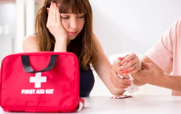 Young family getting treatment with first aid kit — Stock Photo, Image