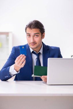 Pasaportlu genç işadamı seyahate hazırlanıyor.