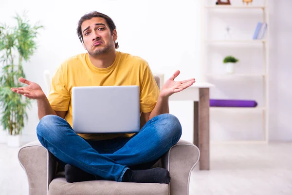 Young handsome man with computer at home — Stock Photo, Image