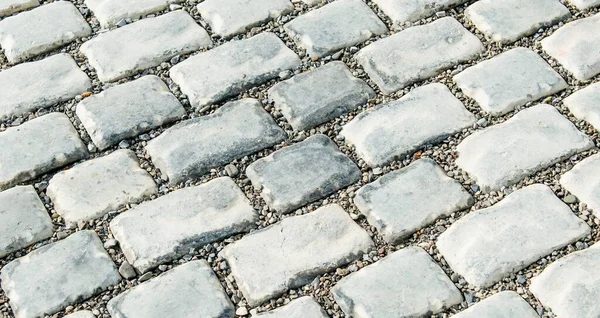 Straße gepflastert mit Pflastersteinen für den Hintergrund — Stockfoto