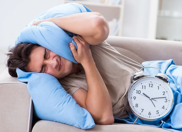 The man having trouble waking up with alarm clock — Stock Photo, Image