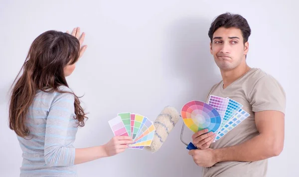 The young family doing renovation at home - painting walls — Stock Photo, Image